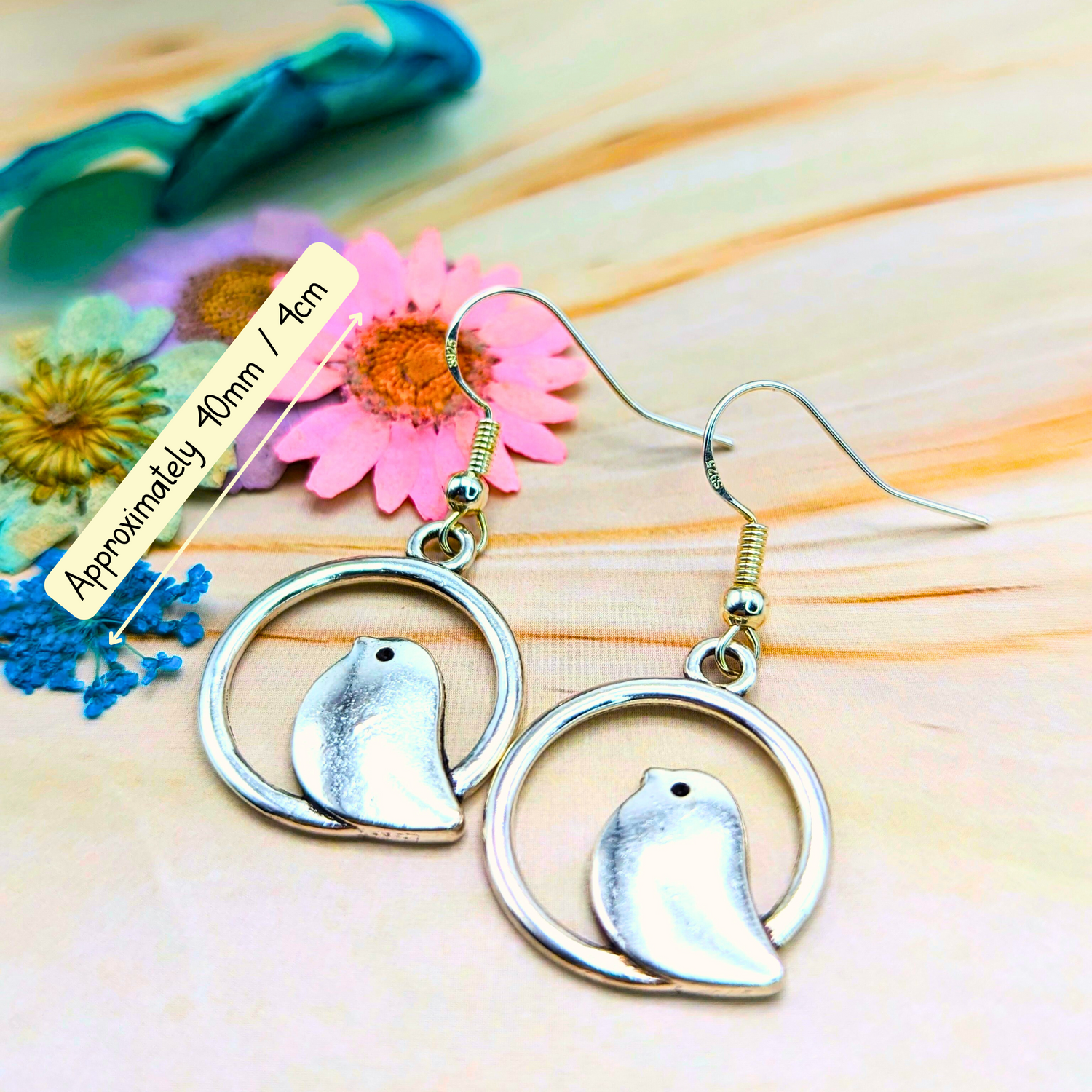 Bird lovers will adore these Beautiful Bird Earrings by Silver Sunbird. Made from 925 Sterling Silver, they feature circular frames and measure around 40mm. Placed on wood, they&