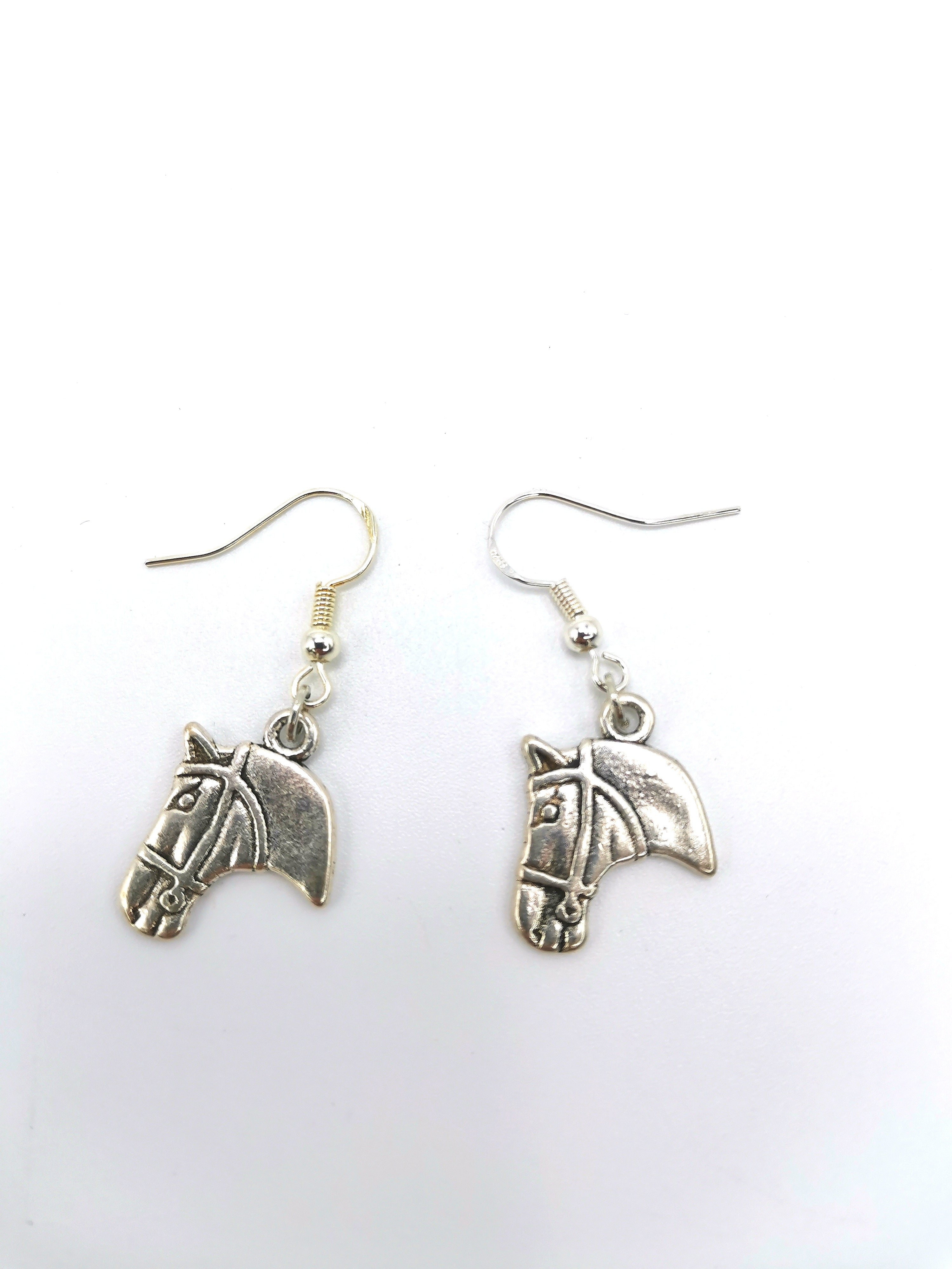 The Take The Reins Equine Earrings by Silver Sunbird feature sterling silver charms with detailed horse heads, capturing the elegance of equestrian charm jewelry.