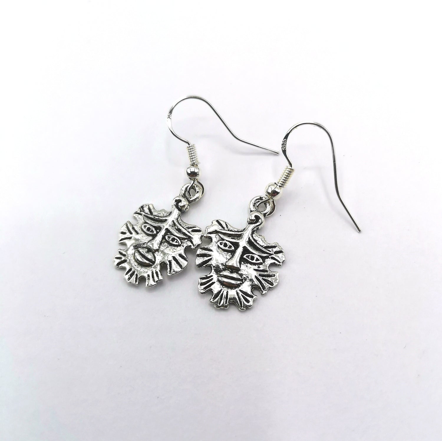 Gentle Green Man Sterling Silver Earrings by Silver Sunbird feature detailed lion face charms and manes, beautifully displayed on a white background—ideal for fans of unique pagan jewellery.