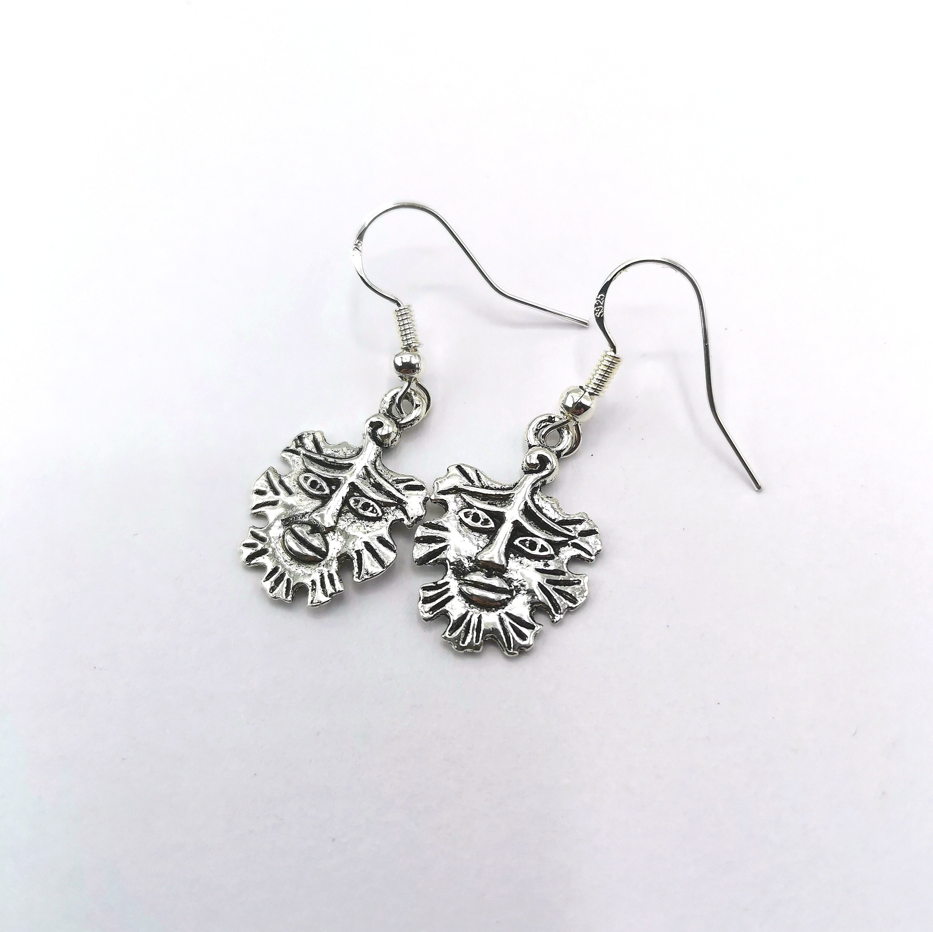 Gentle Green Man Sterling Silver Earrings by Silver Sunbird feature detailed lion face charms and manes, beautifully displayed on a white background—ideal for fans of unique pagan jewellery.