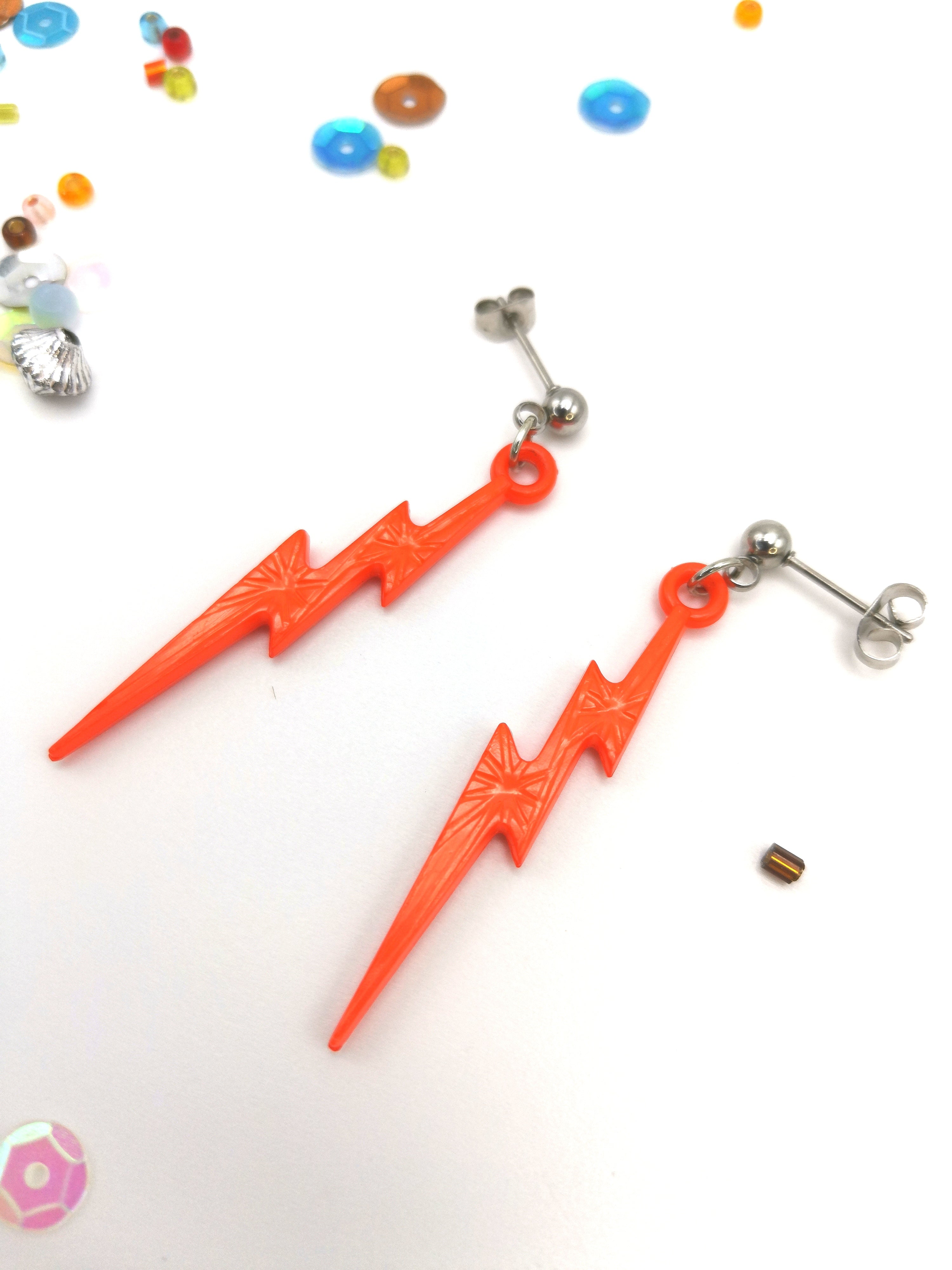 Two bright orange Electrifying Lightning Bolt Earrings from Silver Sunbird&
