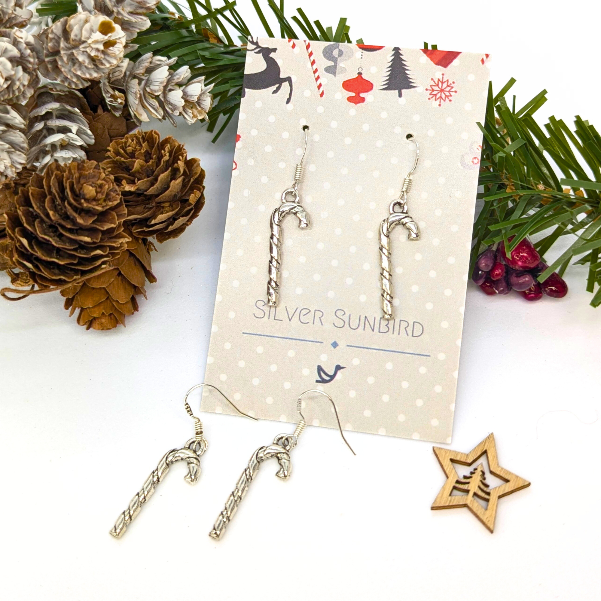 Classic Candy Cane Earrings by Silver Sunbird, presented on a festive Christmas card with holiday designs—an ideal touch of charming Christmas jewelry.
