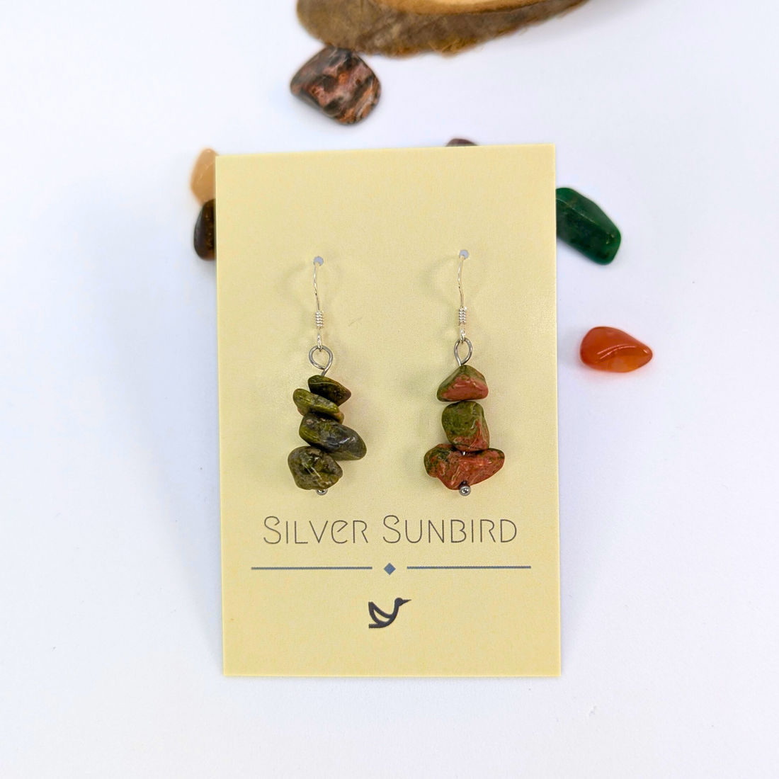 Unakite Gemstone Earrings by Silver Sunbird—green and brown stones on silver hooks, displayed on a cream "Silver Sunbird" card with loose stones; perfect handmade dangle earrings for healing crystal jewelry lovers.