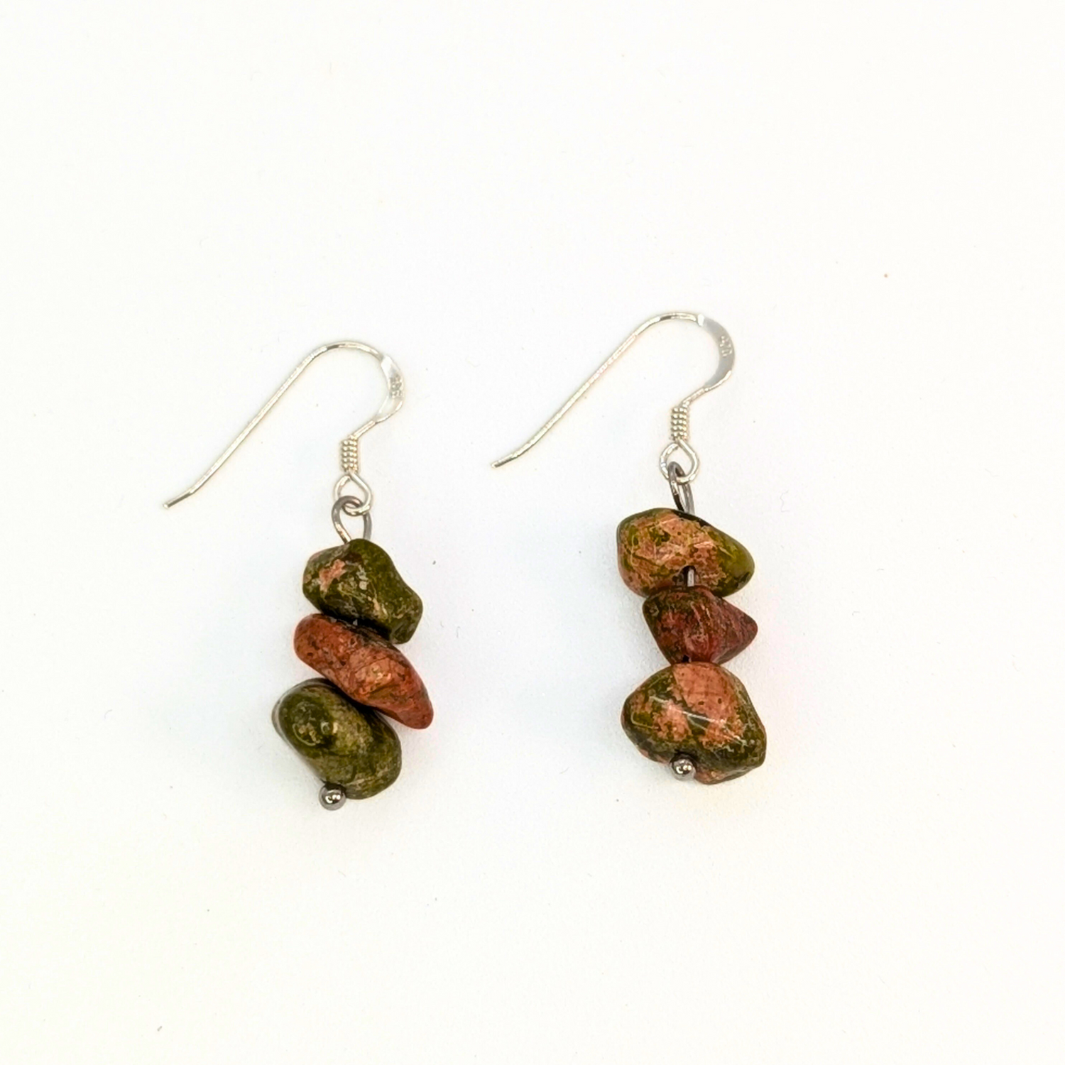 The Silver Sunbird Unakite Gemstone Earrings are handmade dangle earrings with silver hooks, each showcasing three stacked green and reddish-brown Unakite beads. This crystal jewelry is displayed on a white background.